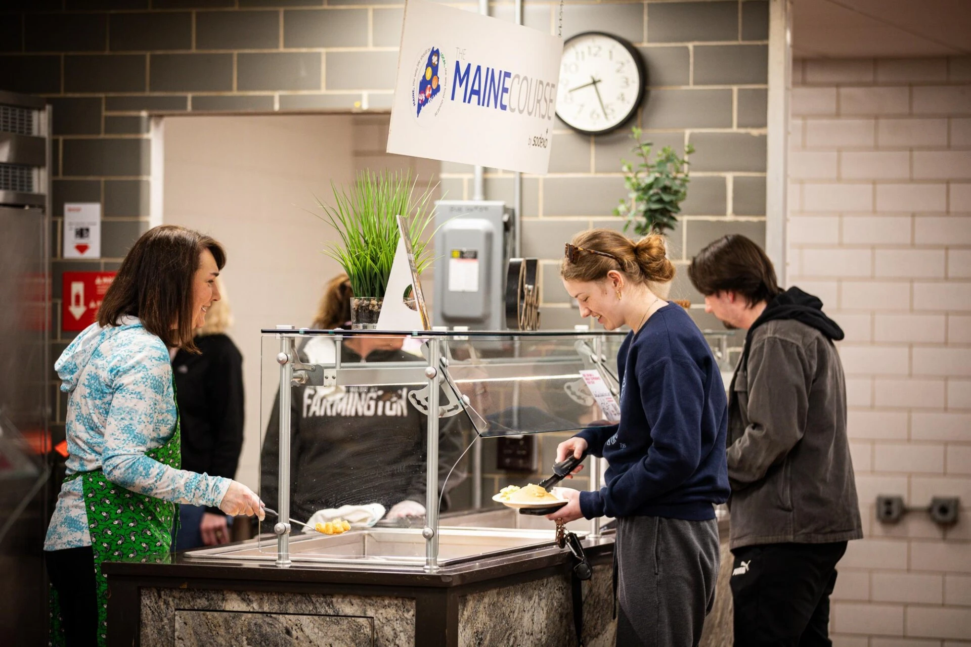 Two Farmington students grab food at the campus dining hall.
