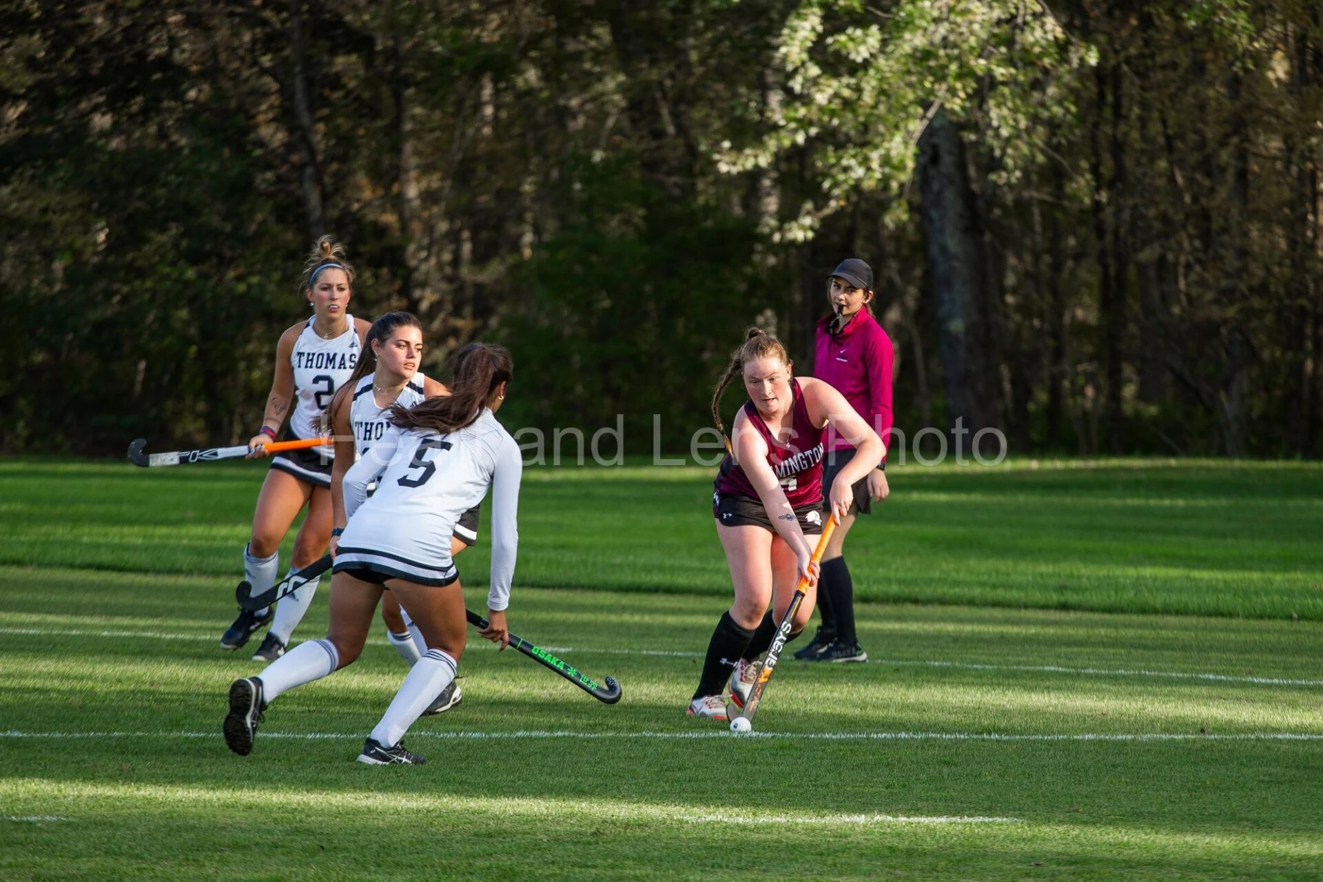 Women's field hockey team plays game.