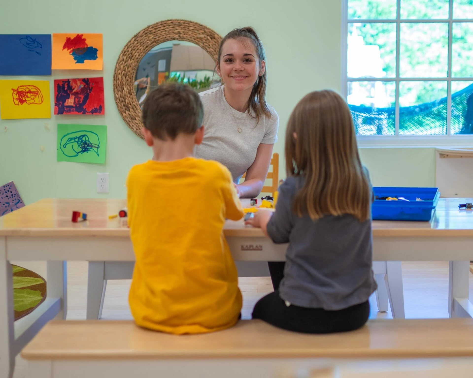 Sweatt-Winter teacher working with young children inside of a classroom.