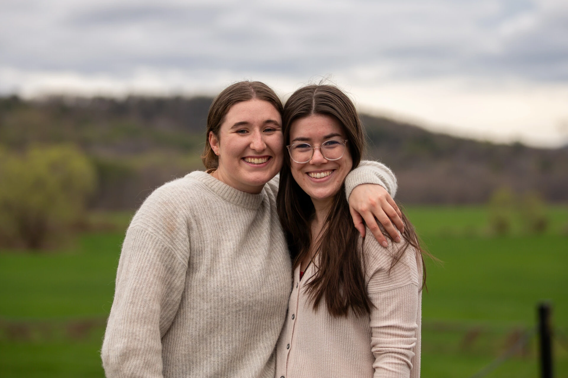 Two female students smiling in field