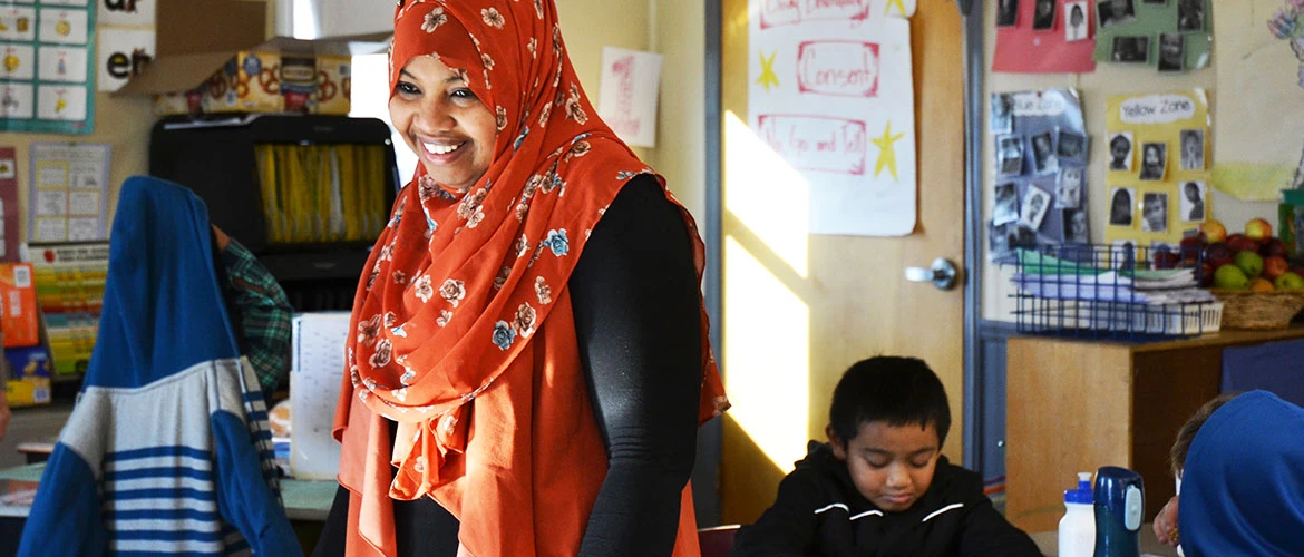 Early childhood education student works in classroom.