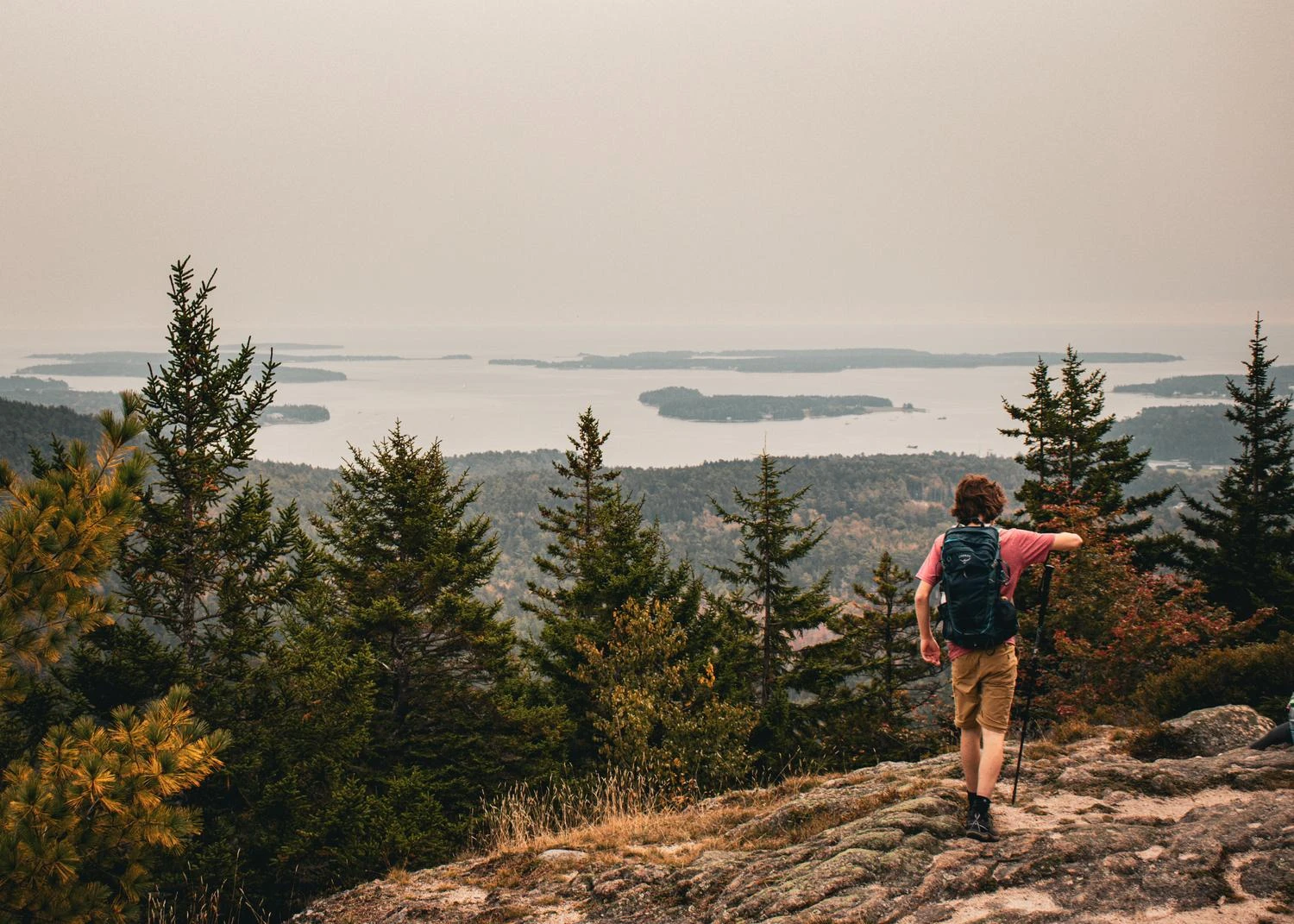 UMF student stands in front of scenic mountain view