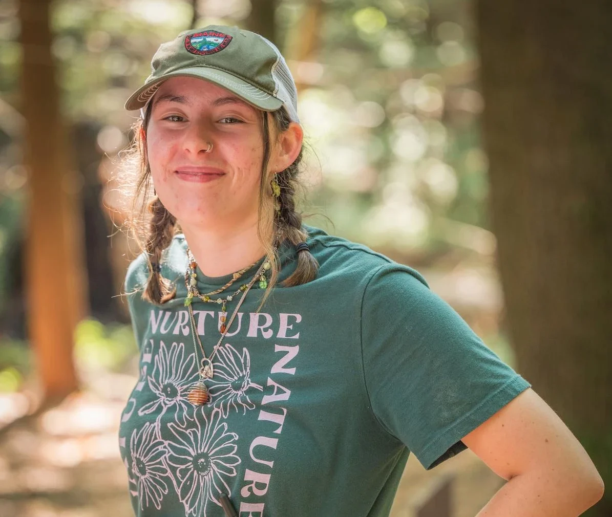 Outdoor recreation business administration student at internship smiles at camera.