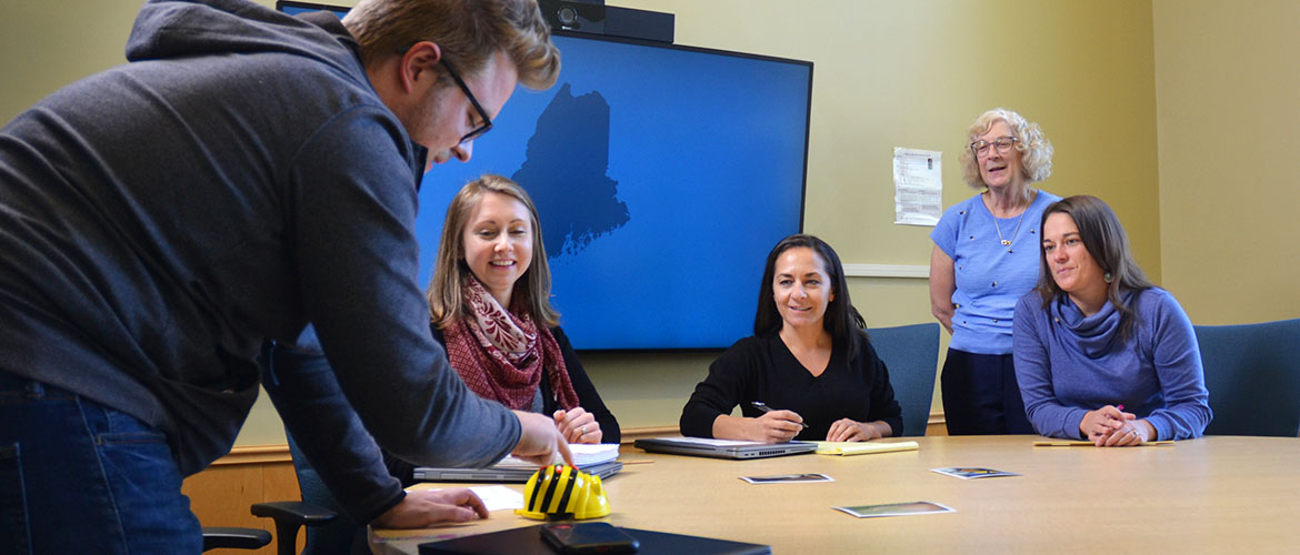 Early Childhood Education (M.S. Ed.) students gather around classroom table.
