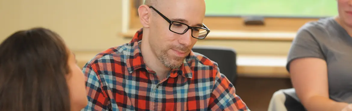 UMF Special Education graduate students reads book