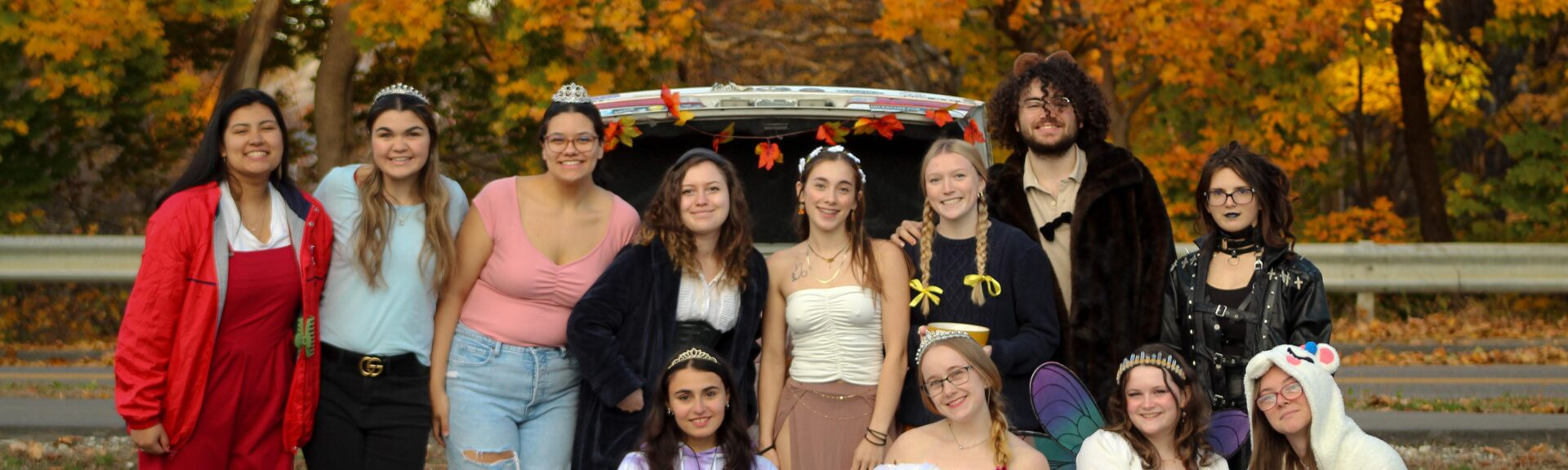 The UMF Dance Team posing outside their Trunk or Treat setup.