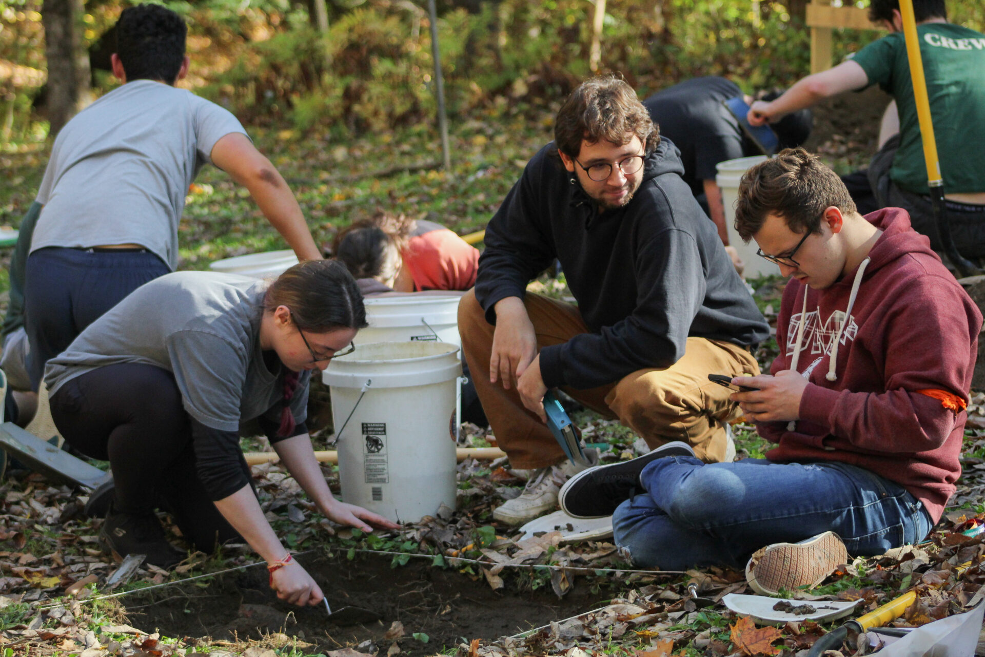 Students participating in an outdoor archaeological dig.