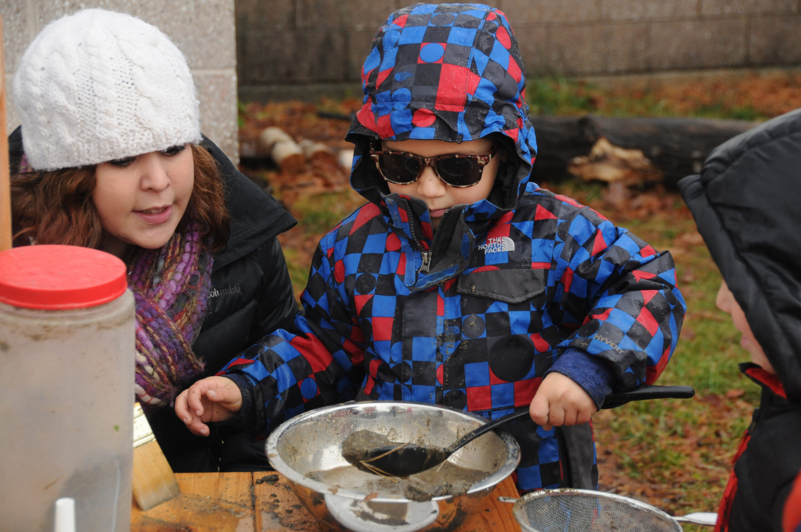 Two young children working with nature