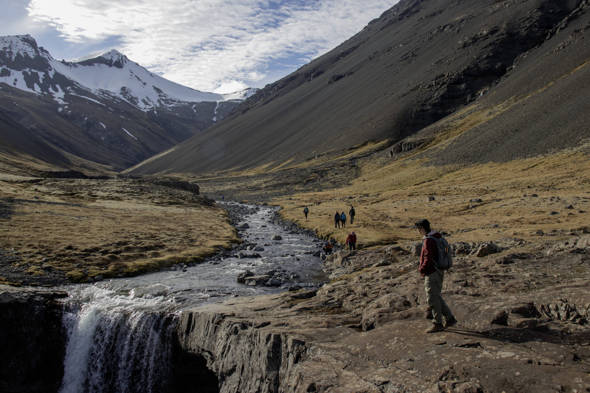 Students relaxing near a stream in Iceland.