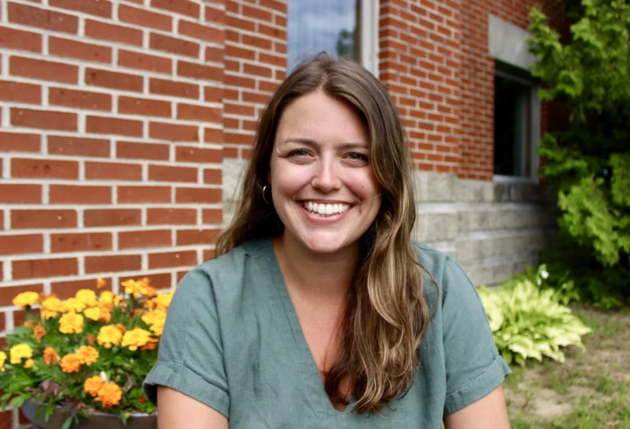 University employee smiling outside