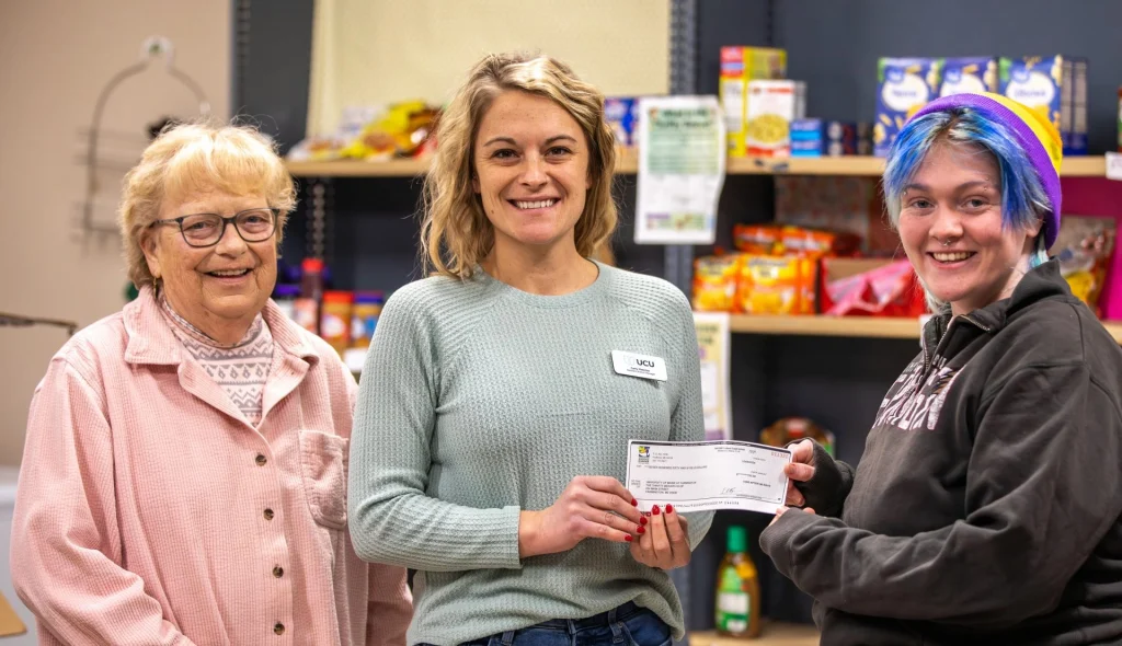 Carly Fletcher, UCU assistant branch manager, presents check to UMF Thrifty Beaver