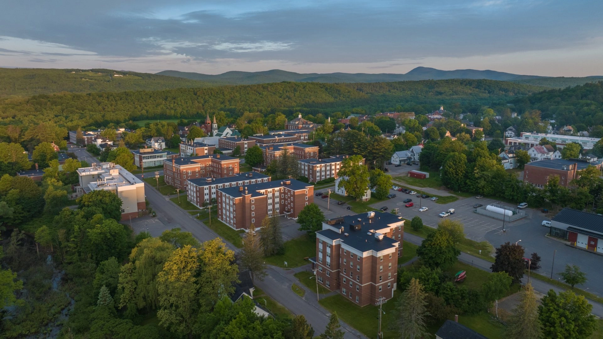 Aerial image at sunrise of University of Maine Farmington Campus with mountains in the distance