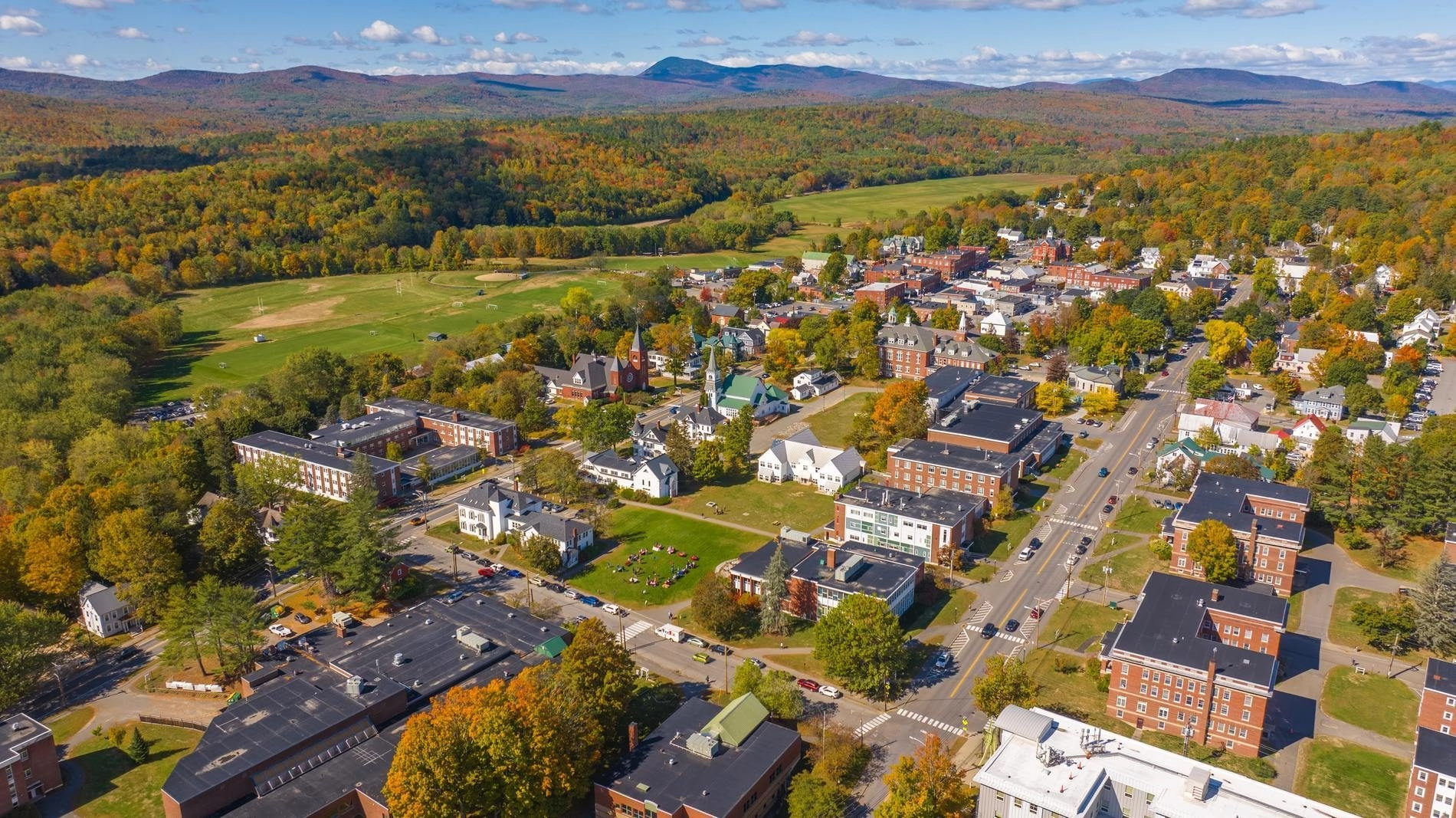 Aerial image of the town of Farmington with mountains in the background