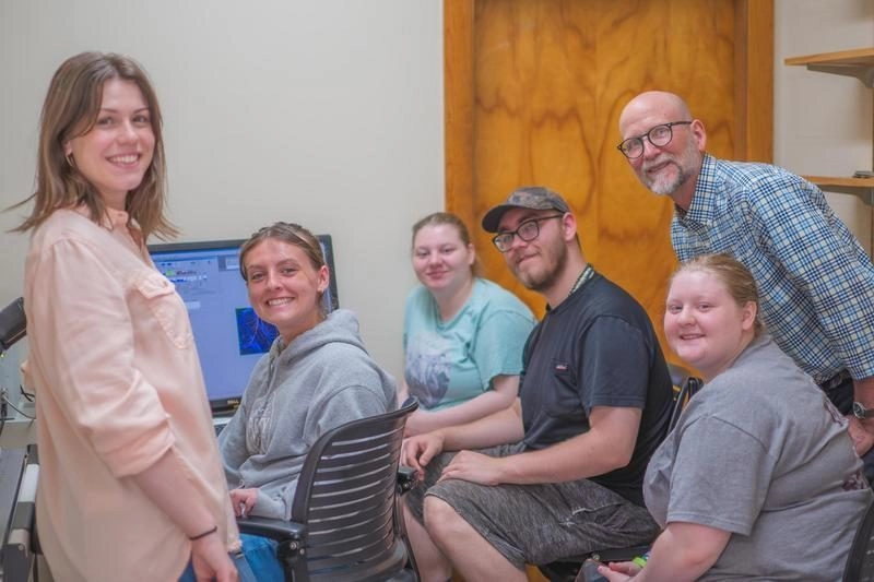 Students gathering around computer