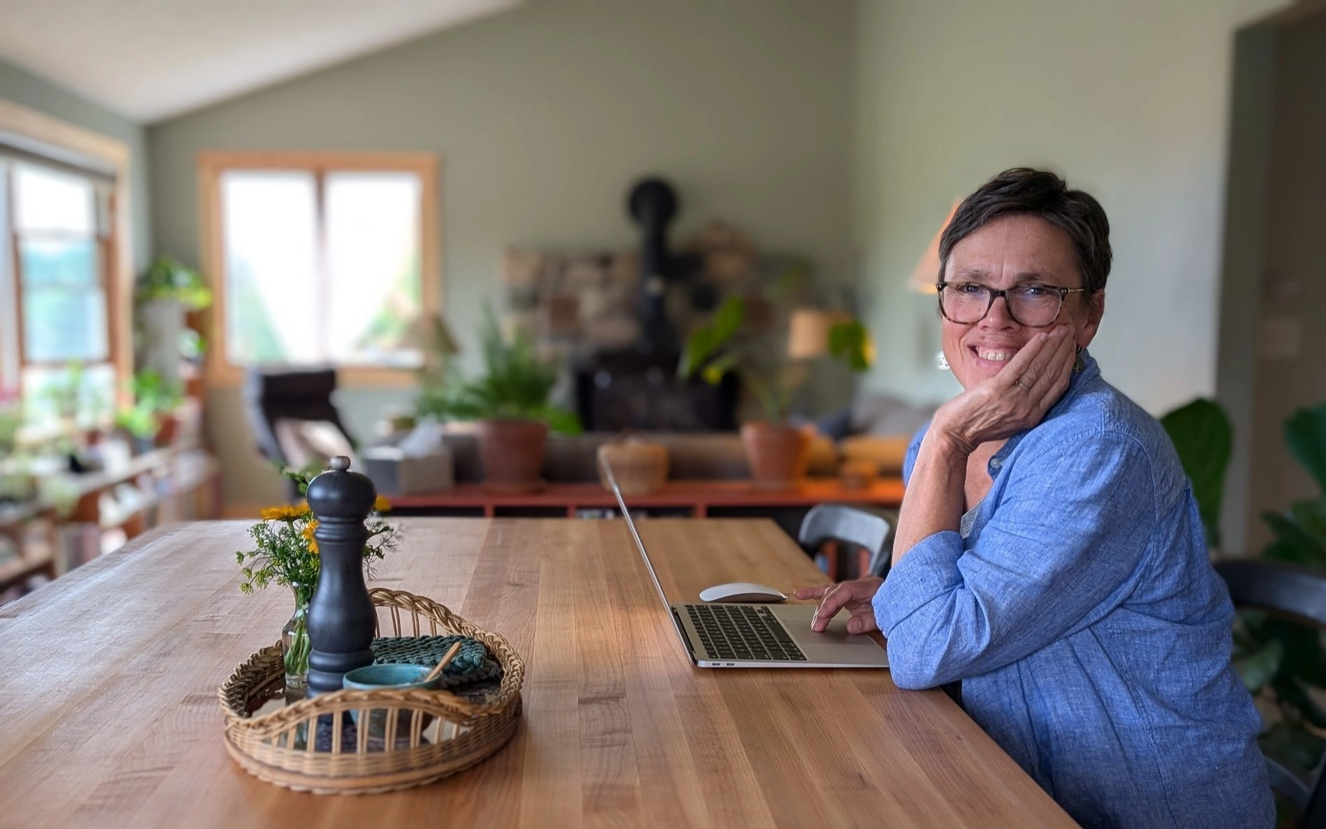 Professor sitting at a table working on a laptop
