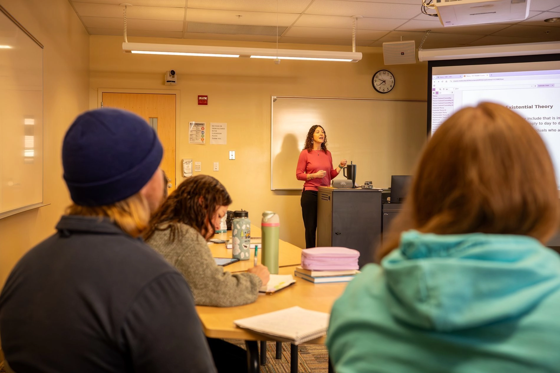 Teacher in front of classroom of grad students