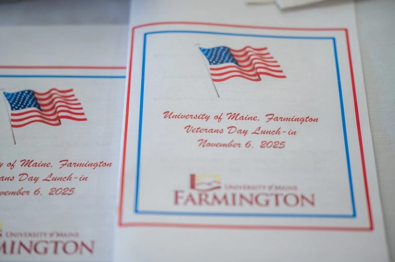 Image of folder saying University of Farmington veterans day lunch