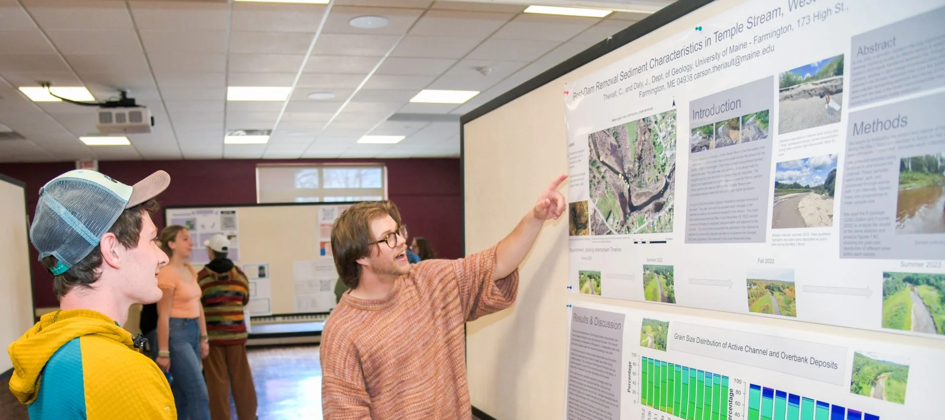 Student sharing his Symposium poster.