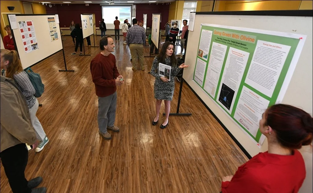 Student sharing a poster session on Symposium Day