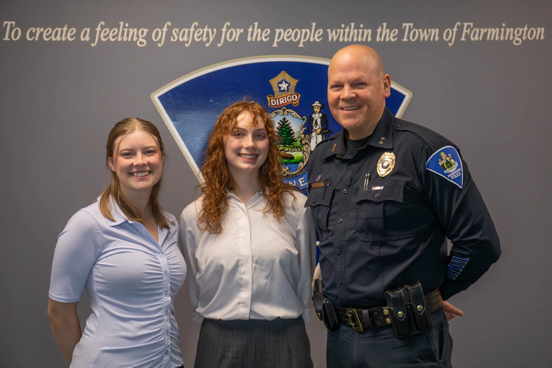 UMF student interns Grace White and Sydney Booth with Farmington Police Chief Kenneth Charles