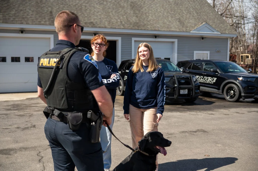 Farmington Police Sergeant Ethan Boyd introduces UMF interns Sydney Booth and Grace to his K9 Hook