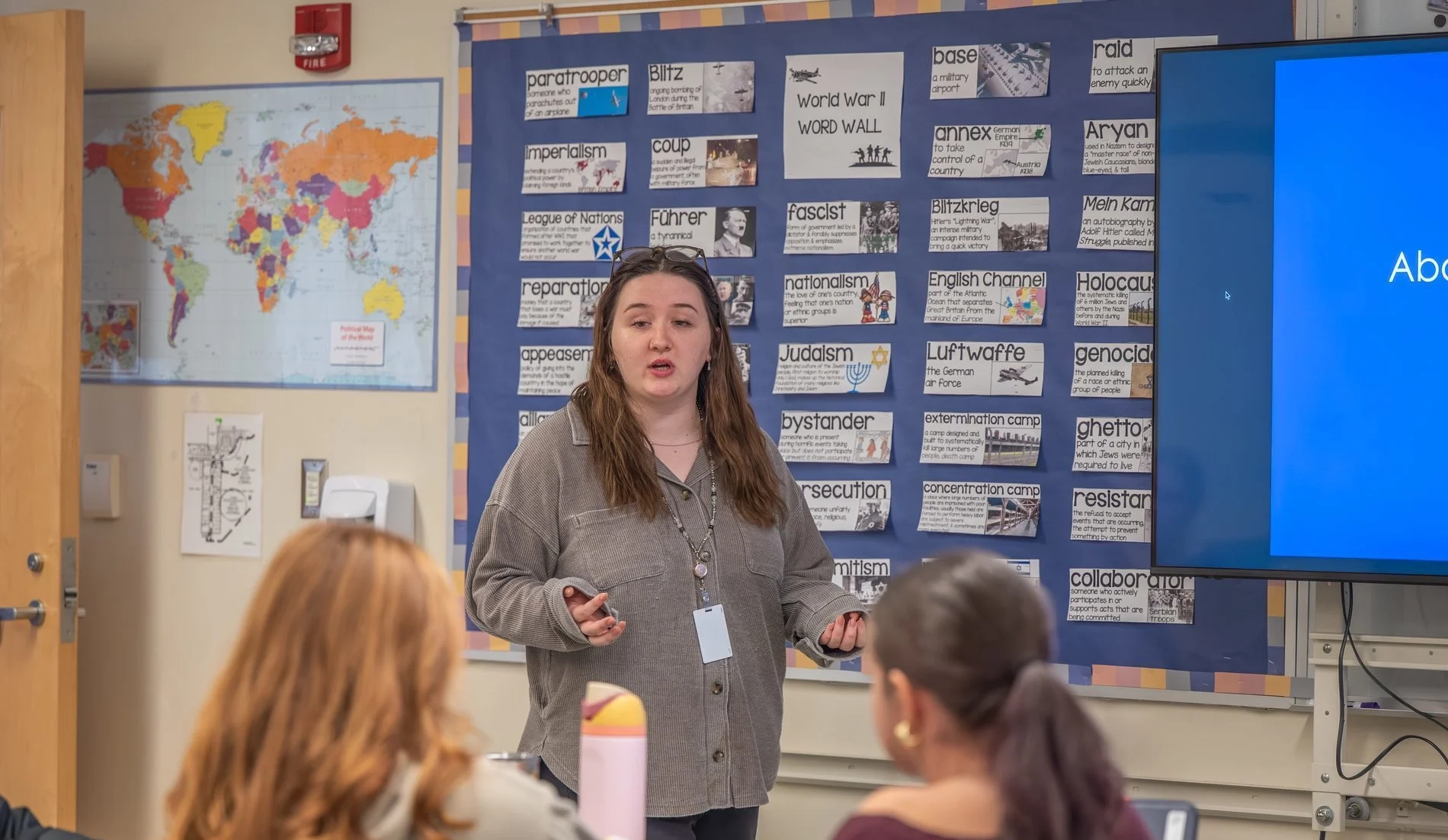 Teacher in front of students at front of class