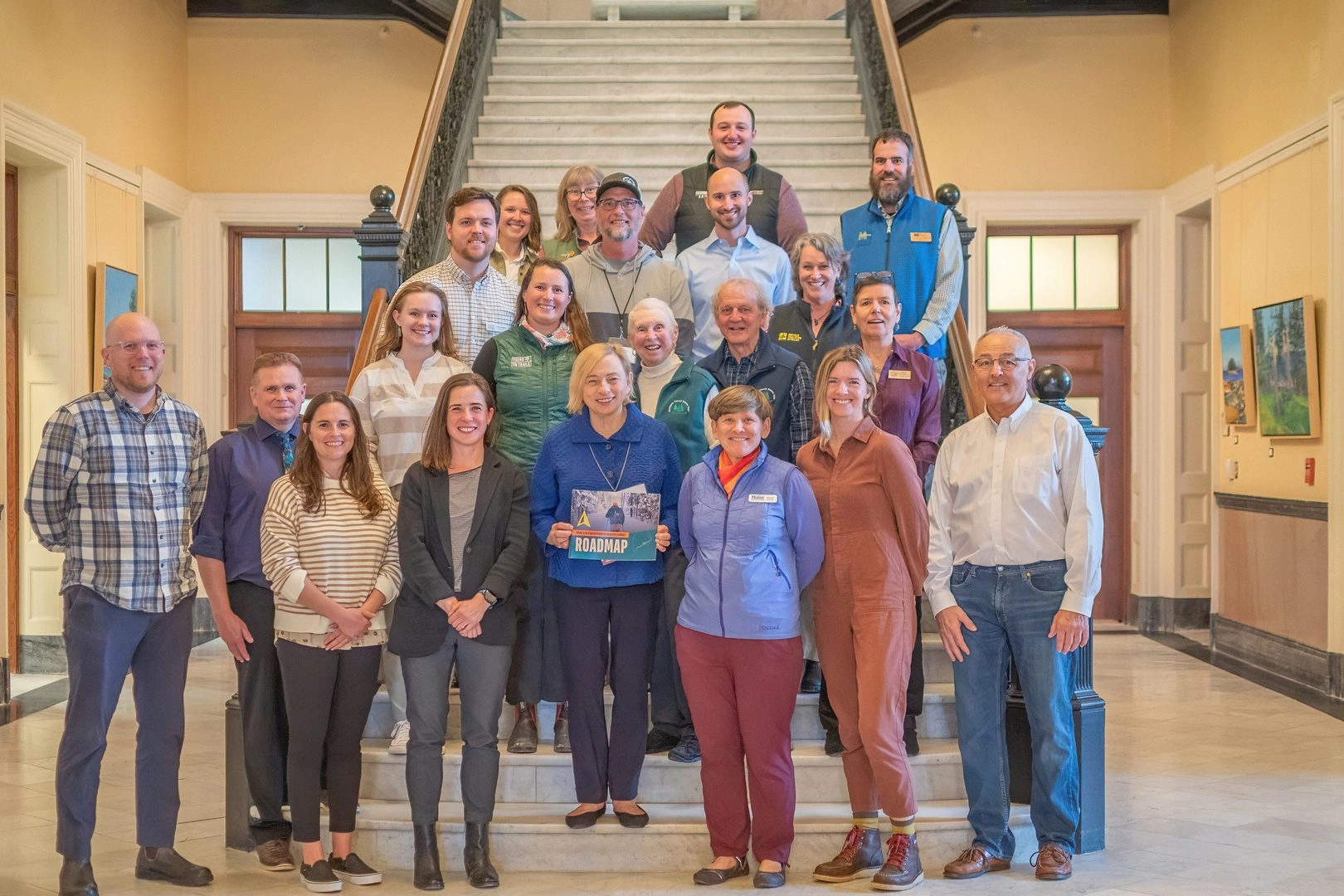 Group posing in Maine Capitol Building with Governor.