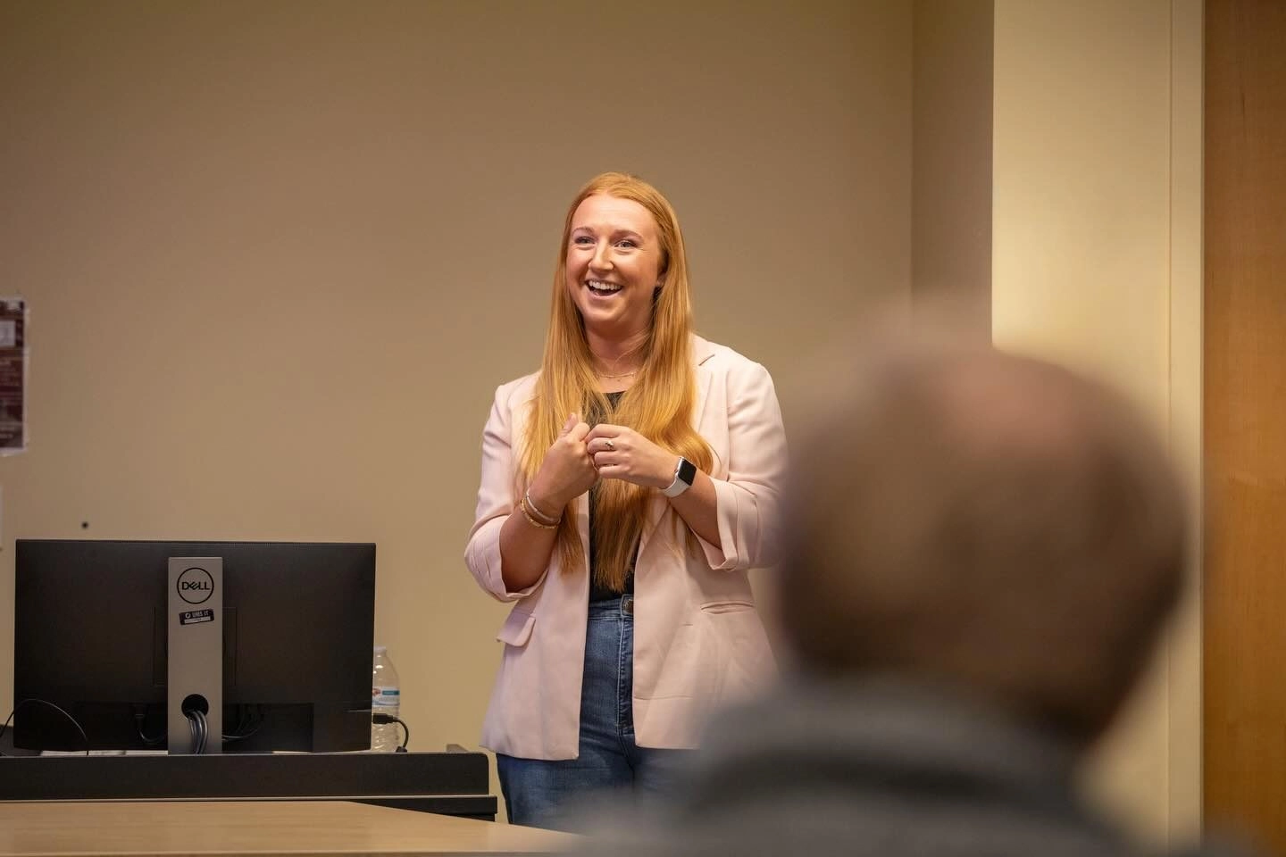 Alum standing in front of classroom