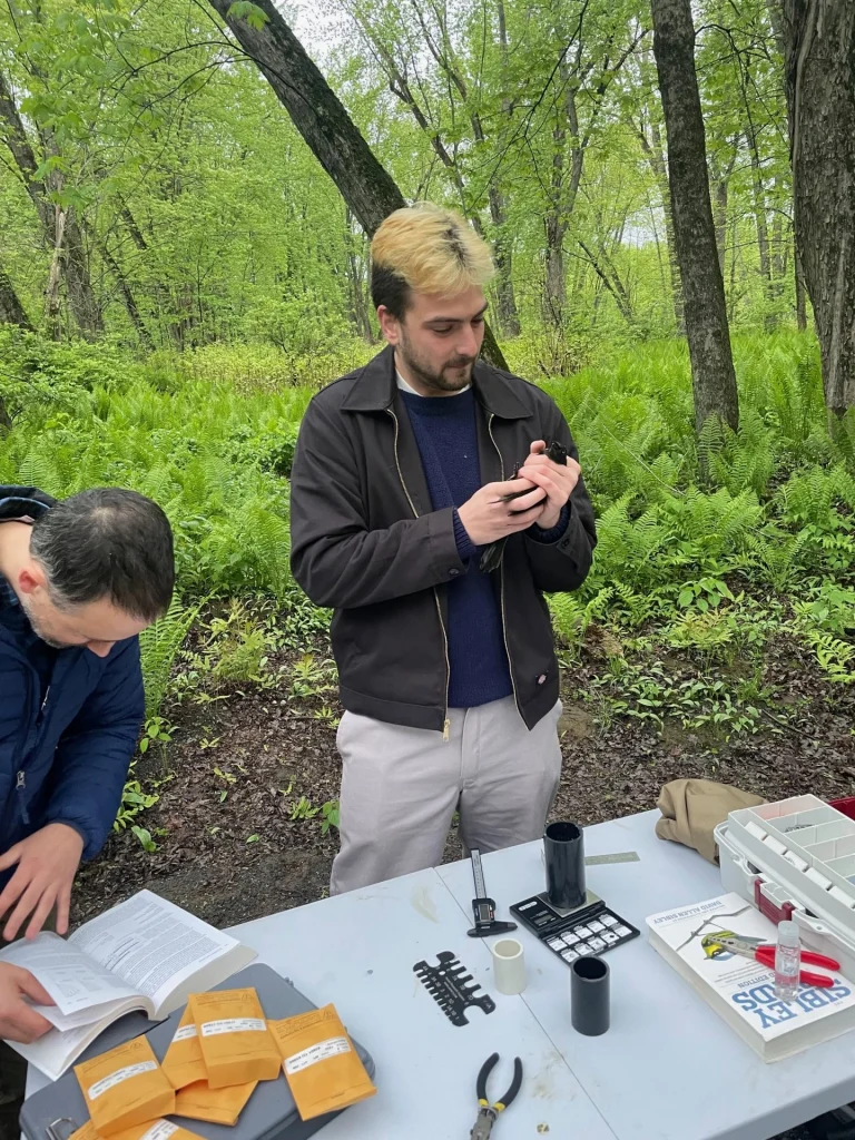 Taking and recording measurements of birds on Sandy River Trails.