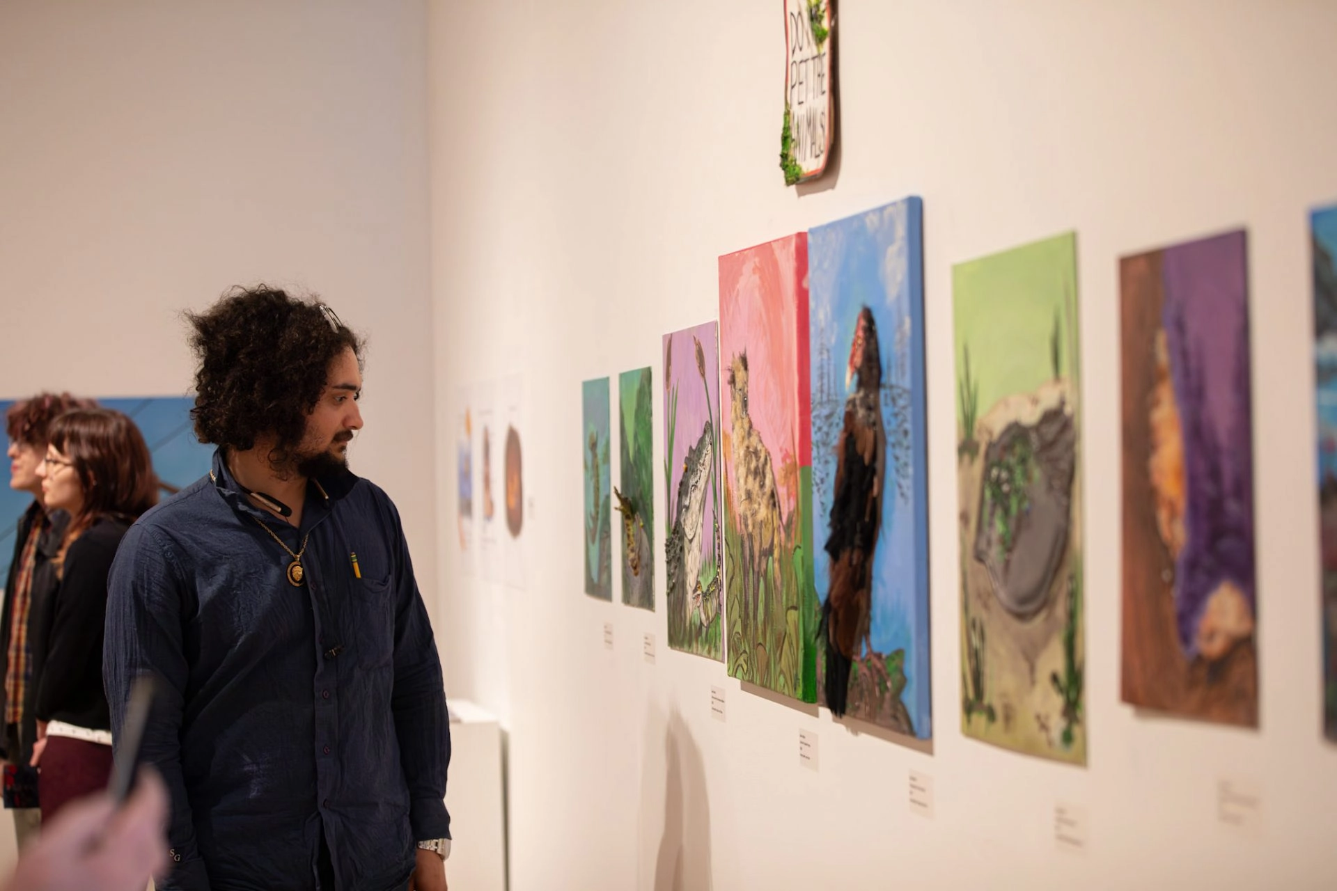 Man looking at art on a gallery wall
