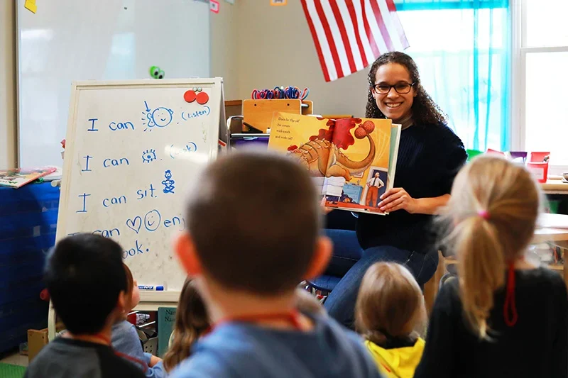 Teacher reading a picture book in front of students