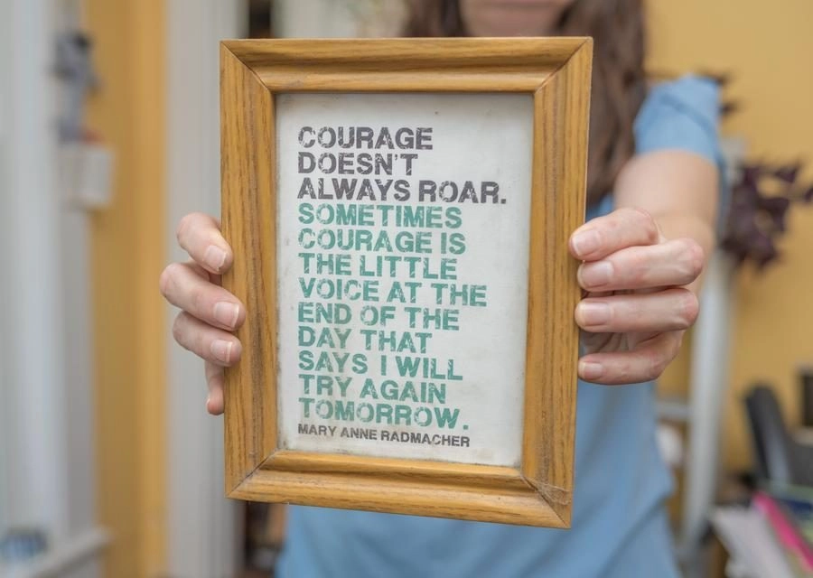 Framed quote held by two hands: 