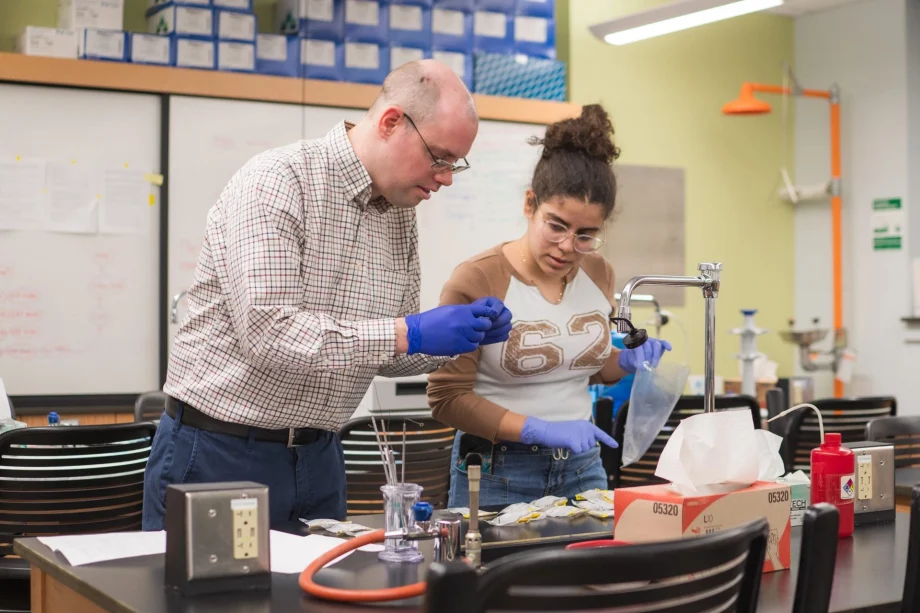 Male professor and female student preparing samples in biology lab